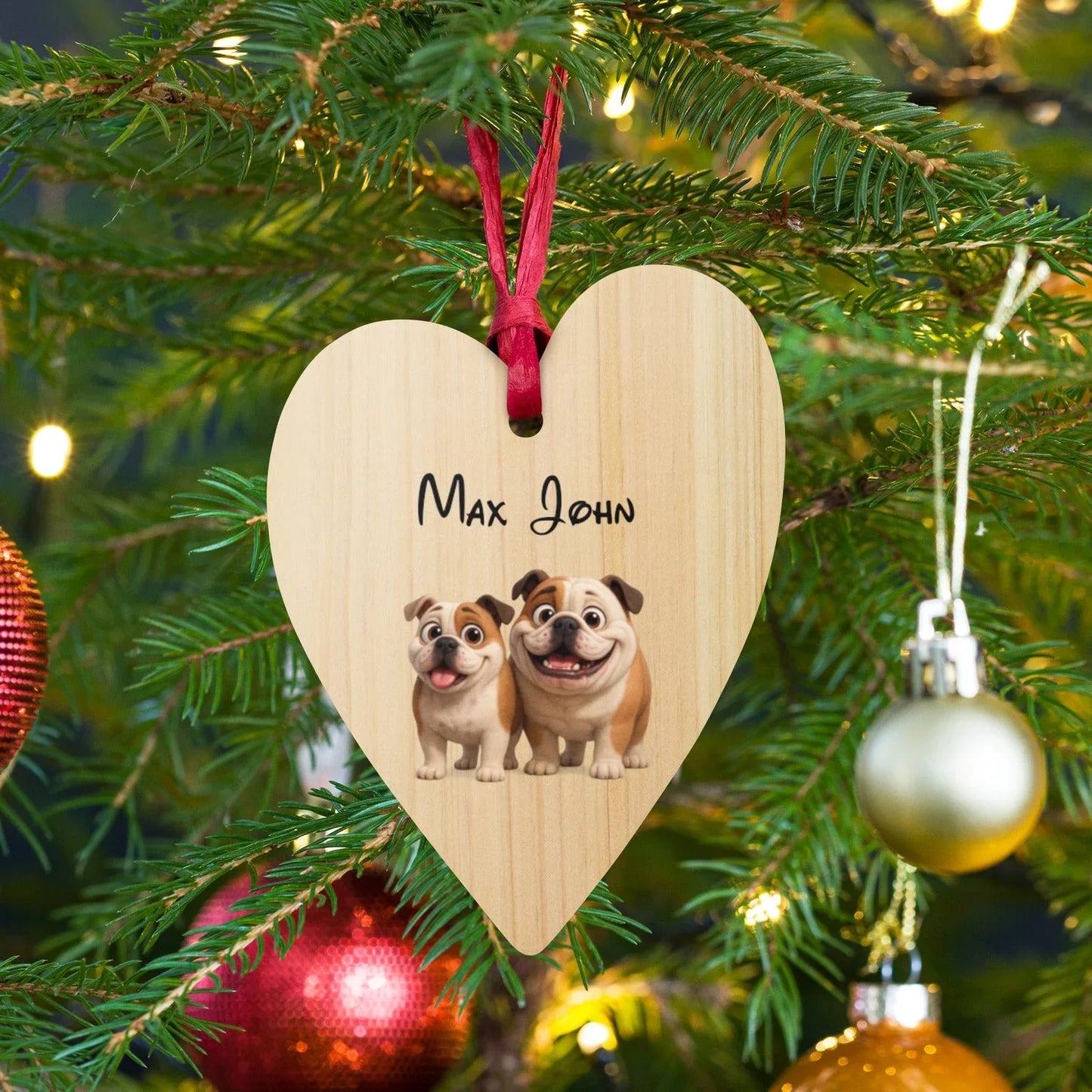 Heart-shaped wooden Christmas ornament with cartoon bulldogs and name Max John on pine tree